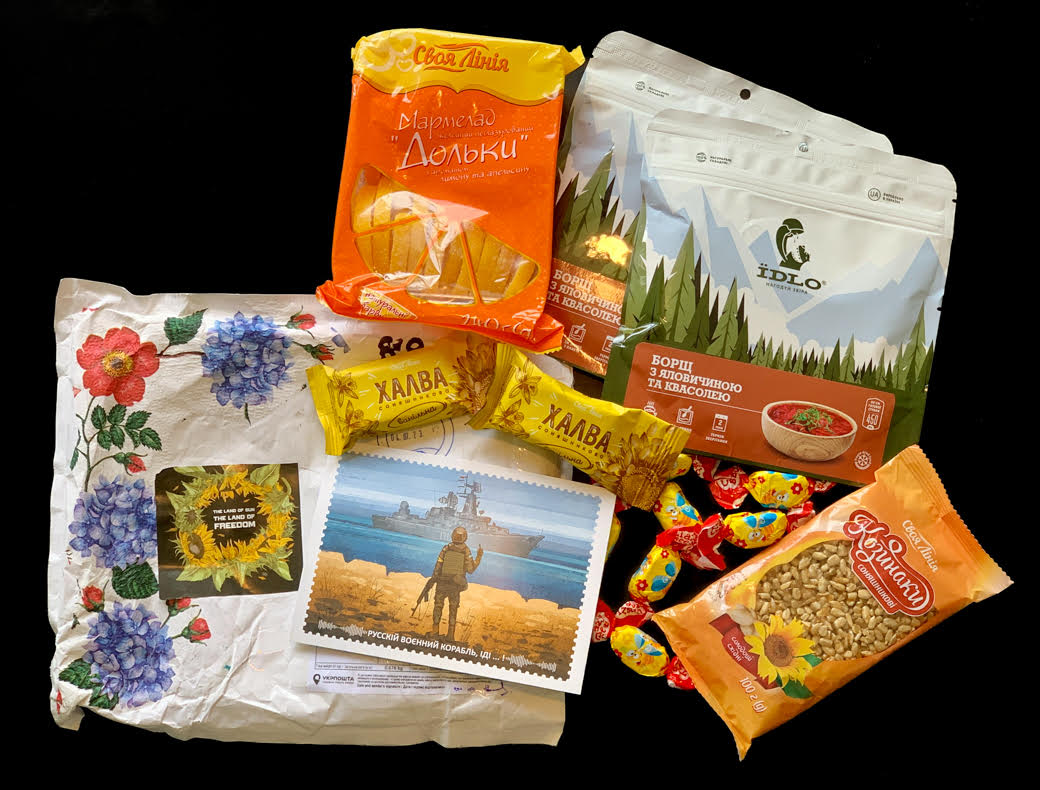 Parcel from Ukraine with halva bars, instant borscht pouches, candies, sunflower seeds and a warship postage stamp