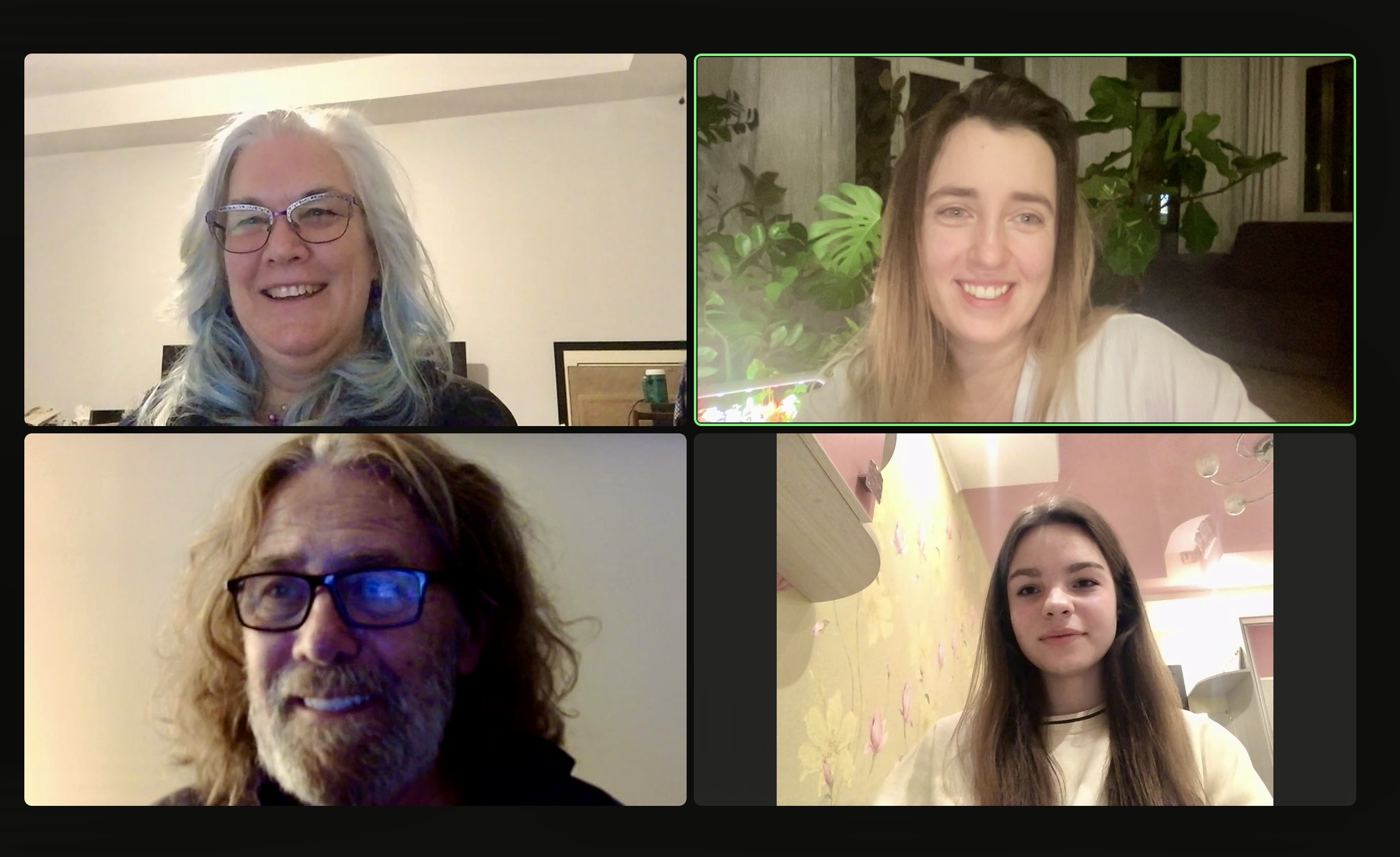 A video call with four people smiling in separate panels